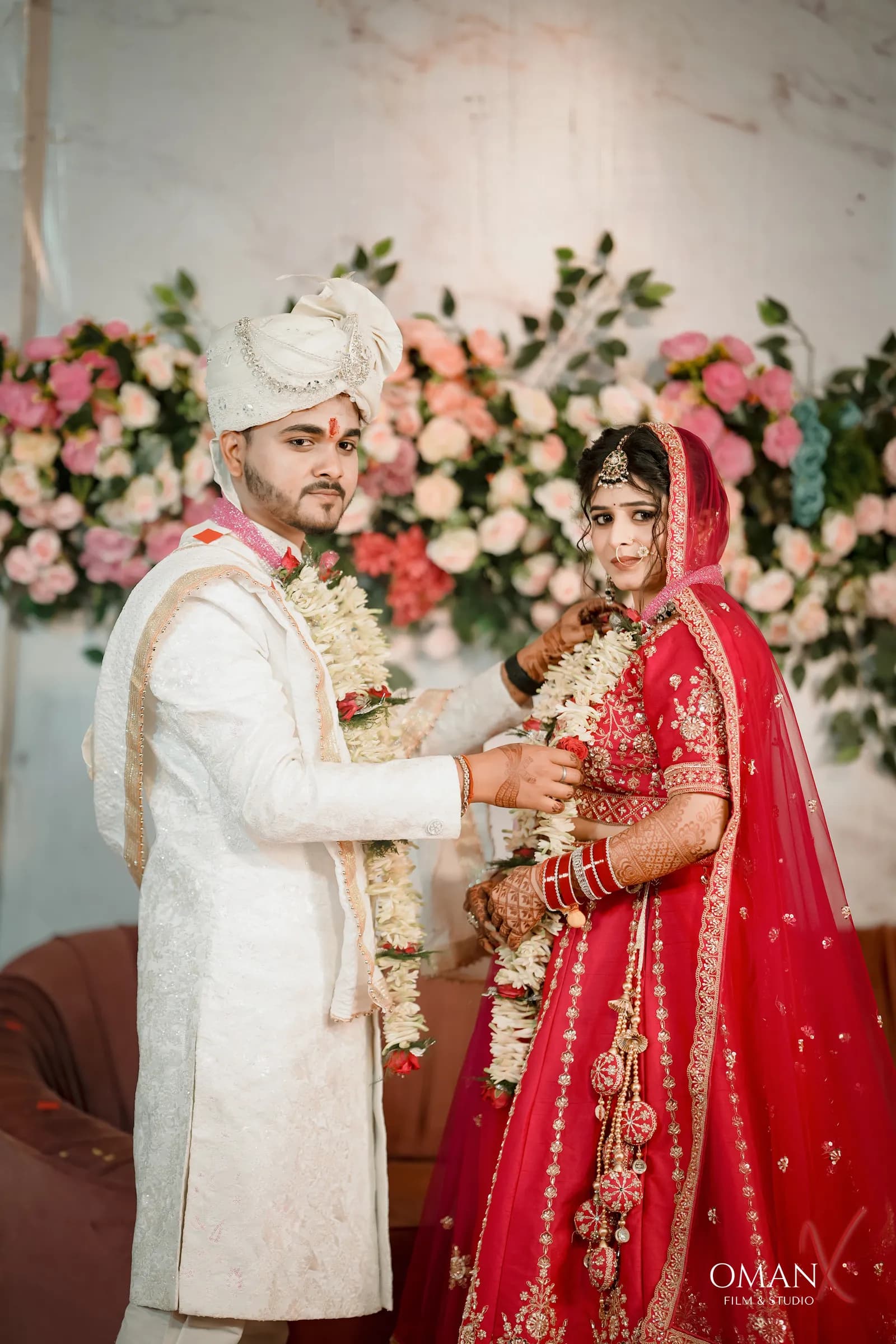 Indian bride and groom exchanging wedding garlands during a traditional wedding ceremony in Jharkhand